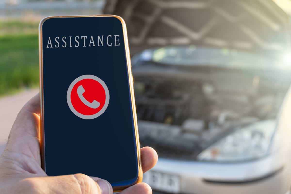 image of phone showing assistance sign with broken down car